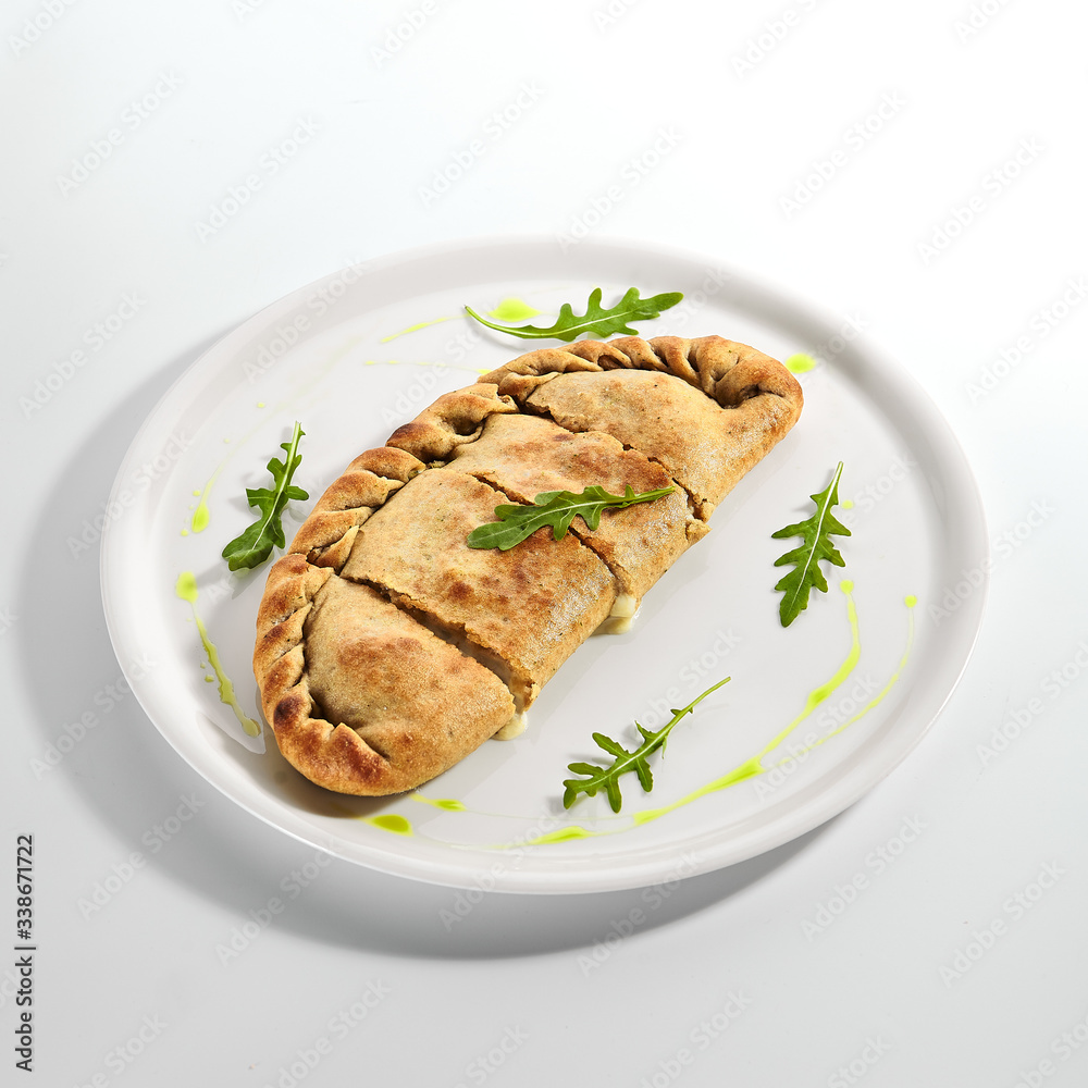 Calzone pizza with Parma ham, tomatoes and mozzarella Calzone pizza with Parma ham, tomatoes and mozzarella