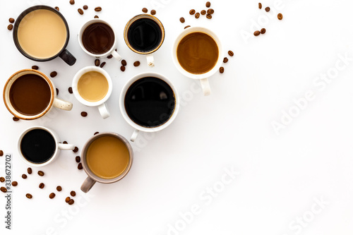 Cups of hot drinks on white table top-down space for text photo