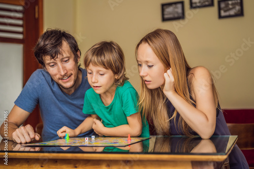 Happy Family Playing Board Game At Home