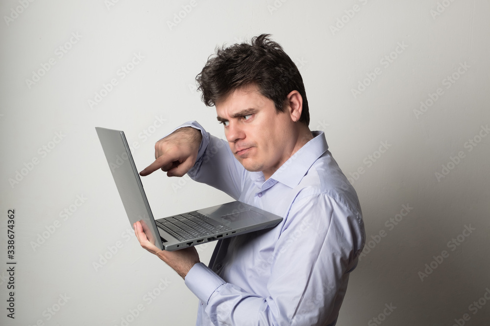 Man with a laptop. Young man works on the laptop remotely. Man with a laptop. Young man works on the laptop remotely.
