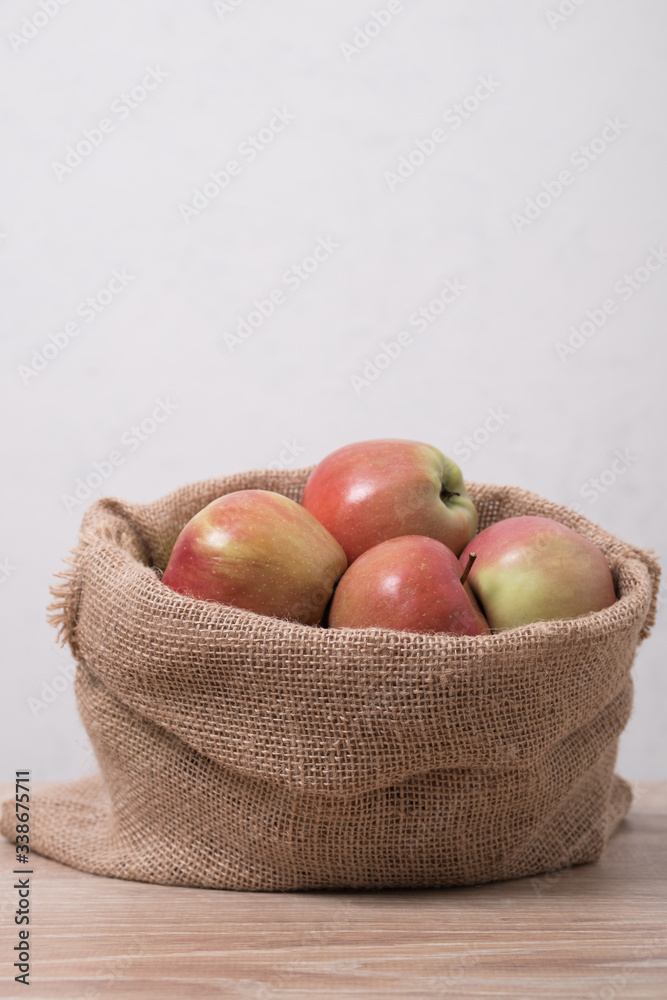 Cloth bag with apples. Burlap sack with rustic apples. Cloth bag with apples. Burlap sack with rustic apples.