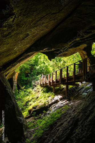 man with backpack walking by trail in caves photo