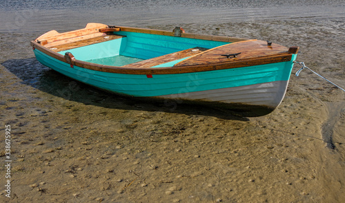 Fishing dinghy beached by the tide on Knysna lagoon photo