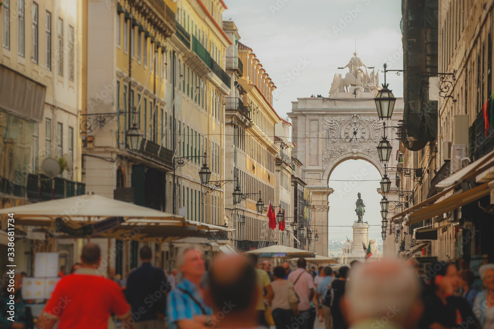 Rua Augusta with the well known arch or Arco da Rua augusta with crouds of tourists looking by on a summer day in Lisbon, Portugal.