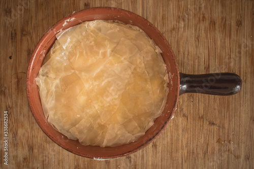 Home made traditional balkan food burek or borek, actually a cheese pita which is called sirnica. Bosnian and turkish traditional food, home made, view from above. photo