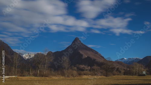 Panorama of mountain Svinjak close to Bovec, Slovenia, in a winter time, but without snow. Famous sharp pointed top of mountain just next to Bovec. © Anze