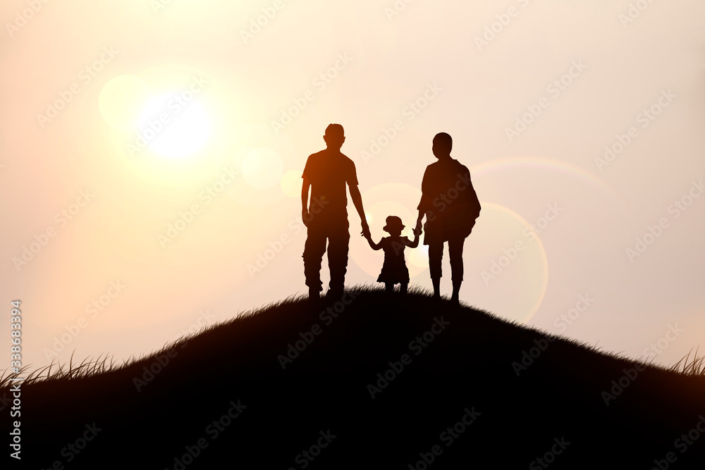 A happy family of four looks at the sunset.