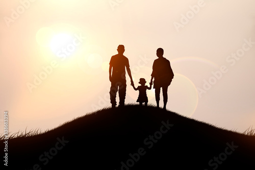 Fototapeta Naklejka Na Ścianę i Meble -  A happy family of four looks at the sunset.