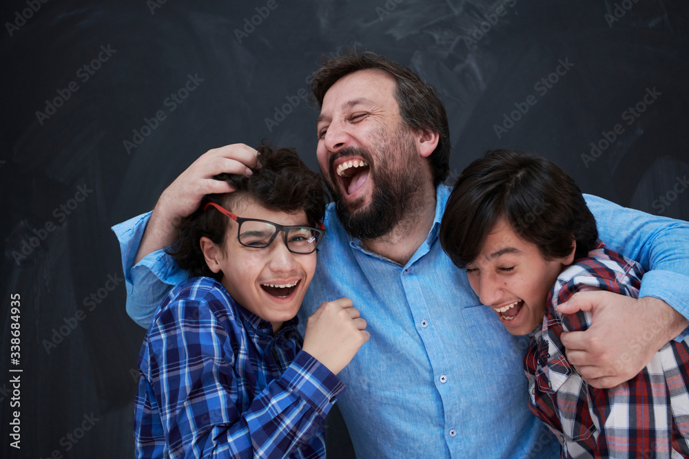 happy father hugging sons