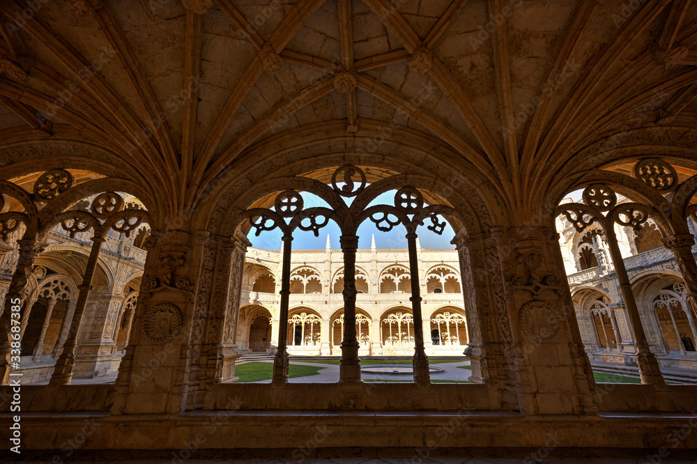 Ornamental and empty cloister and inner courtyard at the historic Manueline style Mosteiro dos Jeronimos (Jeronimos Monastery) in Belem, Lisbon, Portugal.