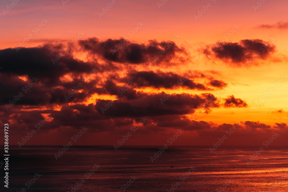 Beautiful clouds at sunset in the sea. Beautiful sunset on the sea in Asia. Warm sun. Landscapes of Bali Indonesia