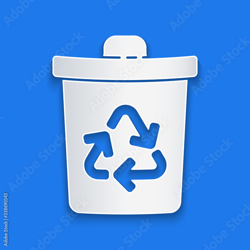 Paper cut Recycle bin with recycle symbol icon isolated on blue background. Trash can icon. Garbage bin sign. Recycle basket sign. Paper art style. Vector Illustration