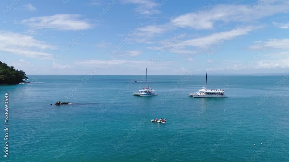Manuel Antonio Costa Rica 02.11.2019 white catamaran yacht excursion in blue bay with empty beach Central America Manuel Antonio Costa Rica 02.11.2019 white catamaran yacht excursion in blue bay with empty beach Central America