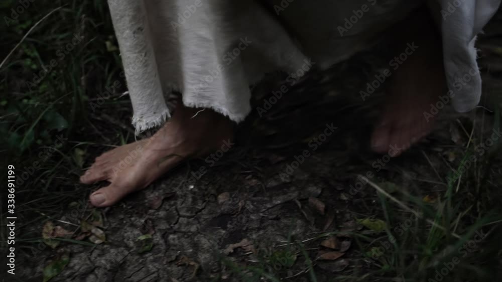 Closeup of Jesus feet walking in forest trees