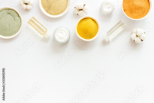 Various kinds of cosmetic clay on white desk top view copy space