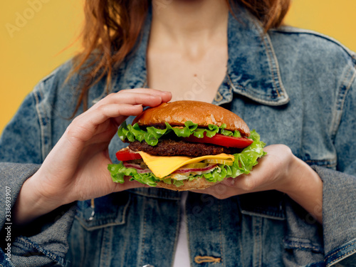 young woman eating hamburger