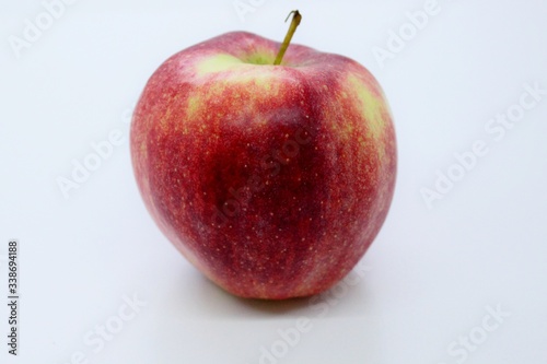 Beautiful red juicy apple located on a gray background