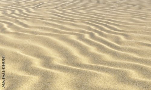 Yellow sand on beach with waves under day sun light closeup