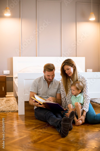 Parents reading book to lit...