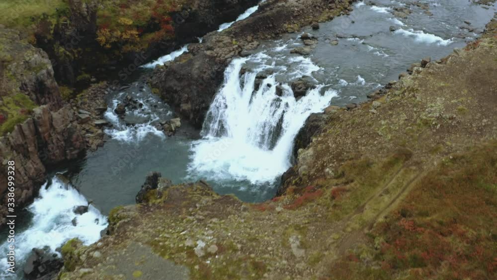 Aerial view of a small waterfall in wilderness. Drone view of a waterfalll in Iceland. Aerial view of a small waterfall in wilderness. Drone view of a waterfalll in Iceland.
