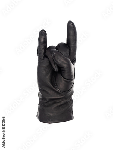 Isolated woman's hand wearing a black leather glove in a horns gesture palm up, middle and ring fingers tucked into the palm by the thumb, index and little fingers extended