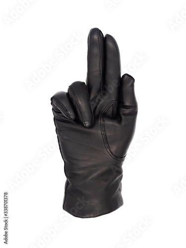 Isolated woman's hand wearing a black leather glove palm up, index and second finger together and pointing, ring and little finger bent. Thumb tucked in