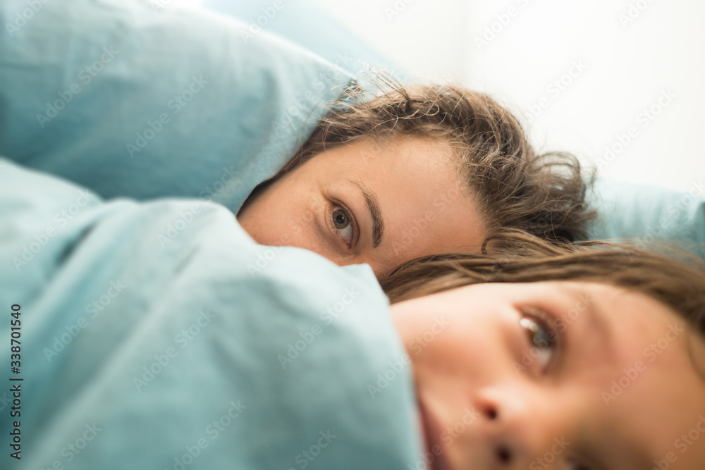 Sleepy child lies in bed with mother. Sleepy child lies in bed with mother.