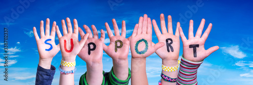 Children Hands Building Colorful English Word Support. Blue Sky As Background