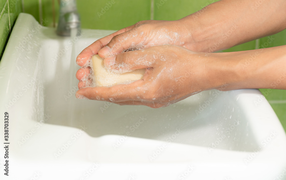 People washing hands with soap in sinks. Apply all over the arms and the nook of fingers. To get rid of dirt that is contaminated including bacteria.