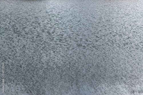 Water surface of a lake with small waves. Texture.