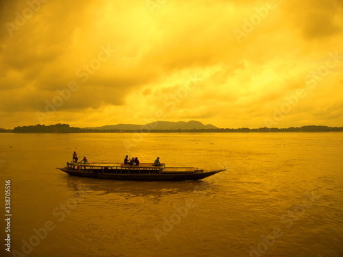 Boat sailing at river brahmaputra during sunset