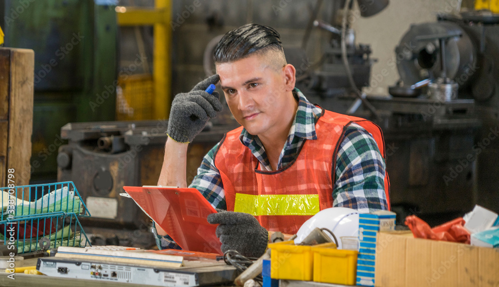 Mechanic engineers work hard Sit and think, plan work in an industrial factory.Heavy Industry concept. Mechanic engineers work hard Sit and think, plan work in an industrial factory.Heavy Industry concept.