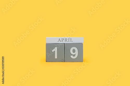 gray wooden cubes of perpetual calendar with the date of Easter April 19
