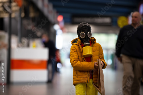 Coronovirus protection. A child in a gas mask with a coronovirus infection. Boy in a store in personal protective equipment. Man defends himself against COVID 19