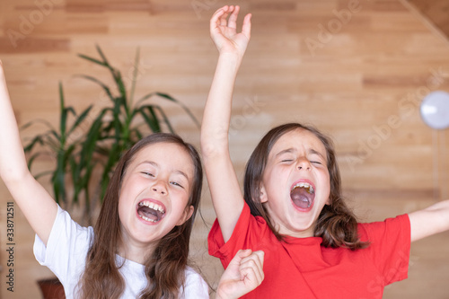 The children woke up early in the morning in their beds and yawned. pajama party