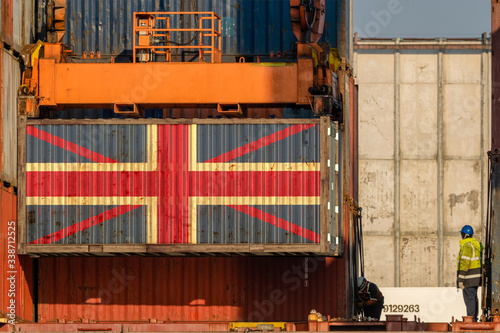 Unloading a container with the flag of Great Britain aboard a container ship