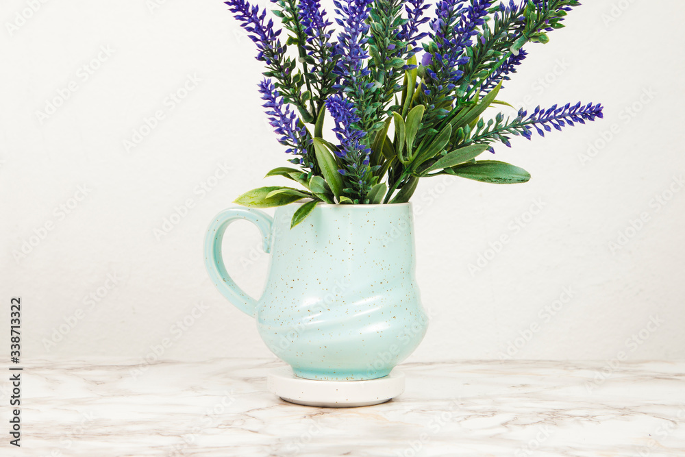 Lavender flowers in a mug on a marble table