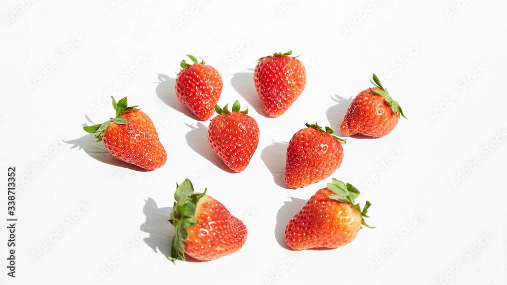 Several ripe sweet tasty berries strawberries on a white surface. Several ripe sweet tasty berries strawberries on a white surface.