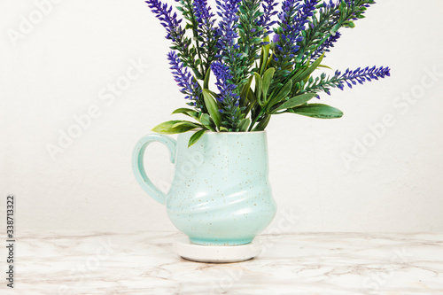 Lavender flowers in a mug on a marble table