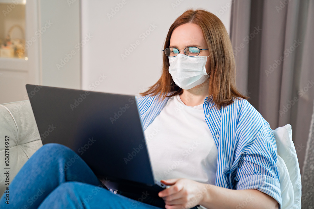 female freelancer in mask work lying with computer female freelancer in mask work lying with computer