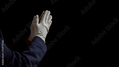 Foto Man Praying Hands in black background. Close up.