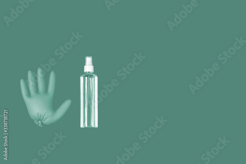 A medical glove and a a bottle of transparent sanitizer with outer place