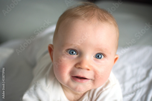 Cute baby boy face, baby with big blue eyes