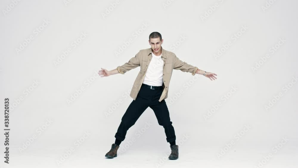 Full length of a stylish young man dancing in studio. Full length of a caucasian man dancing on white background.
Full length of a stylish young man dancing in studio. Full length of a caucasian man dancing on white background.