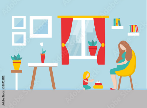 Mother and child is staying at home during epidemy. Girl is playing with toys on the floor. Pregnant Mother is sitting in yellow chair. Some books and paintins around. There is a window with red