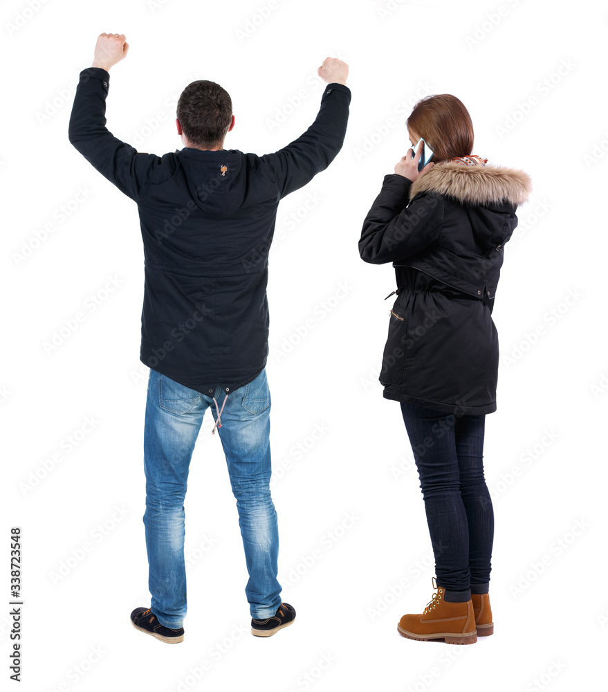 Back view of couple in winter jacket photographed on a mobile phone in winter jacket. Back view of couple in winter jacket photographed on a mobile phone in winter jacket.