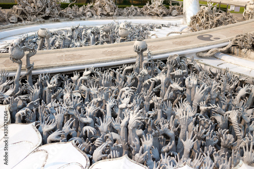 Horrible hands in unique white temple and popular tourist attraction in Chiang Rai (known as Wat Rong Khun) in the North of Thailand