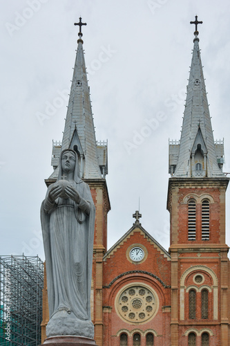 Front facade of Notre-Dame Cathedral Basilica of Saigon and statue of the Virgin Mary. Ho Chi Minh City, Vietnam