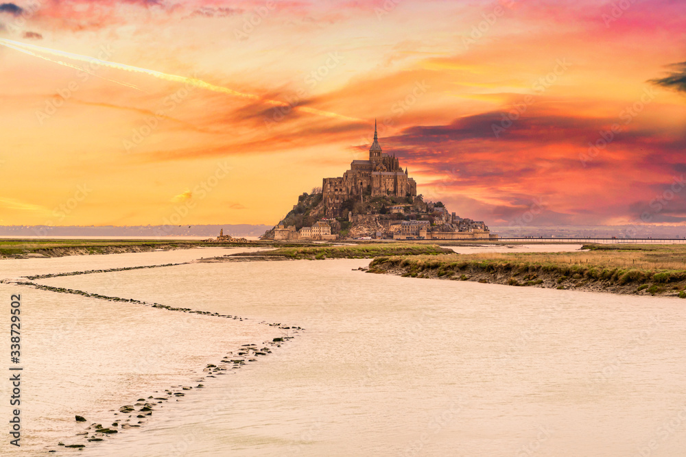 Beautiful view of famous historic Le Mont Saint-Michel tidal island, Normandy, France in beautiful evening twilight at dusk