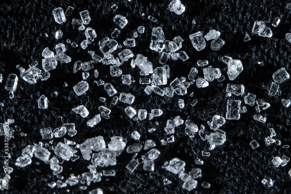 Macro detail of sugar crystal grain on black background. Macro detail of sugar crystal grain on black background.